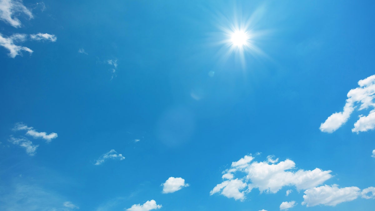The sun shining brightly in the sky