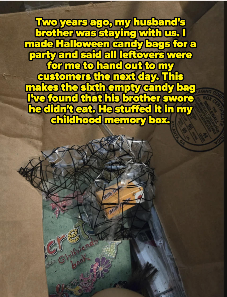 A cardboard box with Halloween decorations, including a netted bag, a "Milk Magic" container, and an activity book labeled "with Girlfriends" partially visible