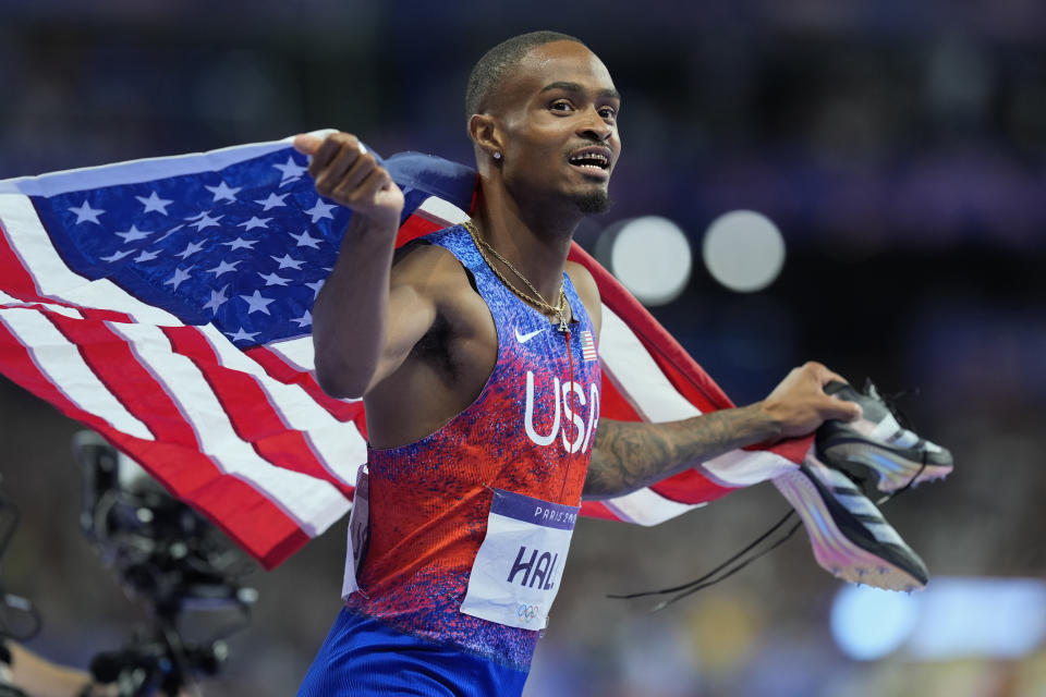 Quincy Hall, of the United States, celebrates after winning gold in the men's 400-meter final at the 2024 Summer Olympics, Wednesday, Aug. 7, 2024, in Saint-Denis, France. (AP Photo/Rebecca Blackwell)