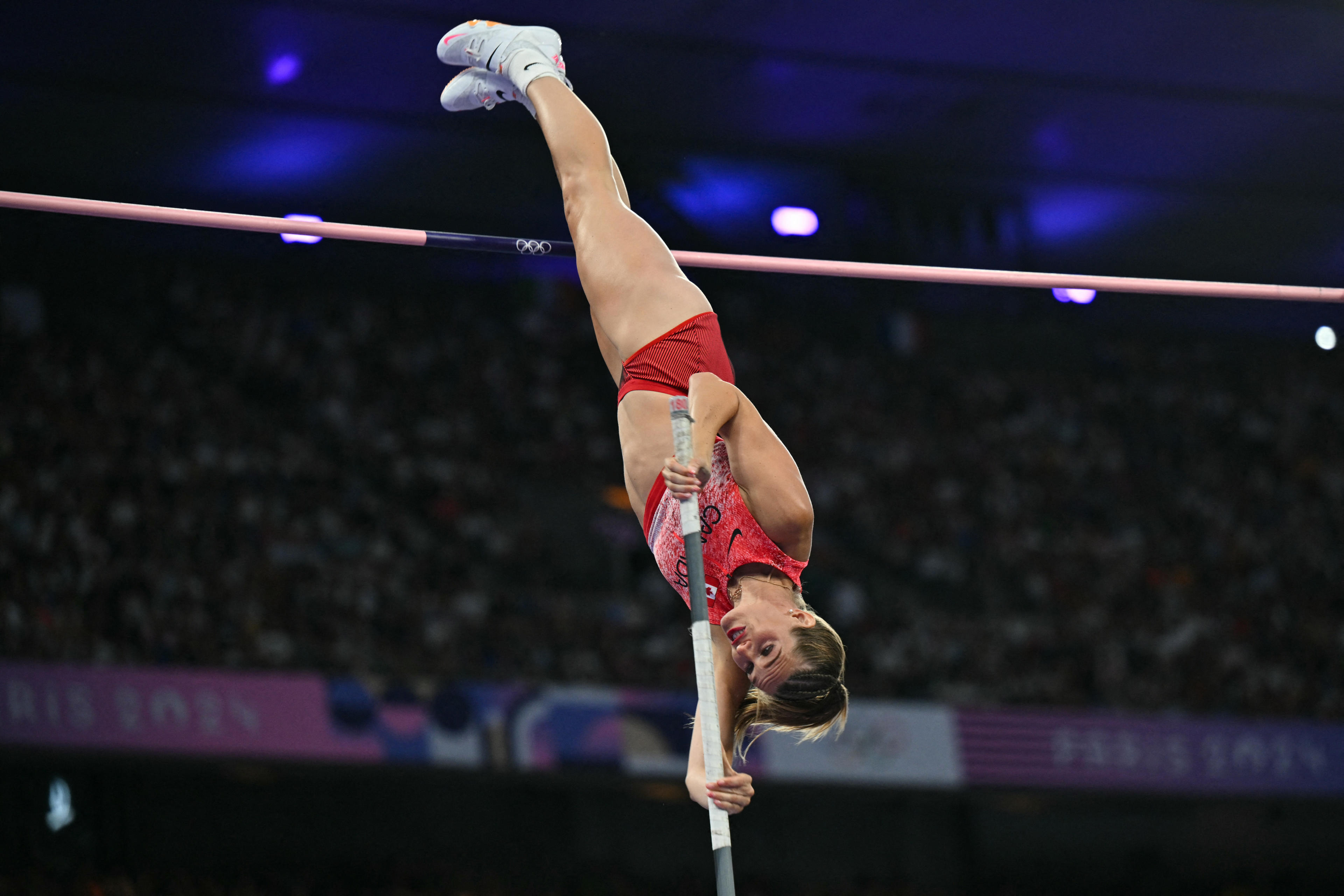 TOPSHOT - Canada's Alysha Newman competes in the women's pole vault final of the athletics event at the Paris 2024 Olympic Games at Stade de France in Saint-Denis, north of Paris, on August 7, 2024. (Photo by Andrej ISAKOVIC / AFP) (Photo by ANDREJ ISAKOVIC/AFP via Getty Images)