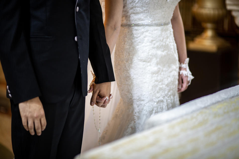 A bride and groom holding hands