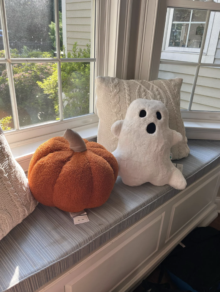 Screenshot of a Reddit post from user CostoRose showing two plush toys, a pumpkin and a ghost, on a window sill. The post mentions Costco's Halloween items