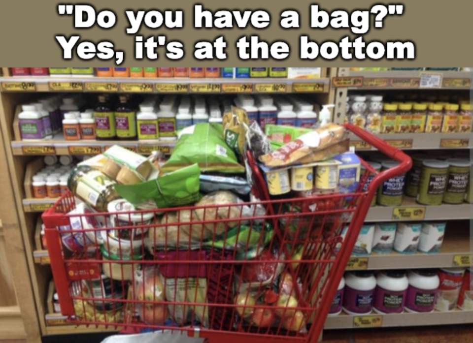 A grocery cart filled with various food items in the store. Text above reads, "Do you have a bag?" and "Yes, it's at the bottom."