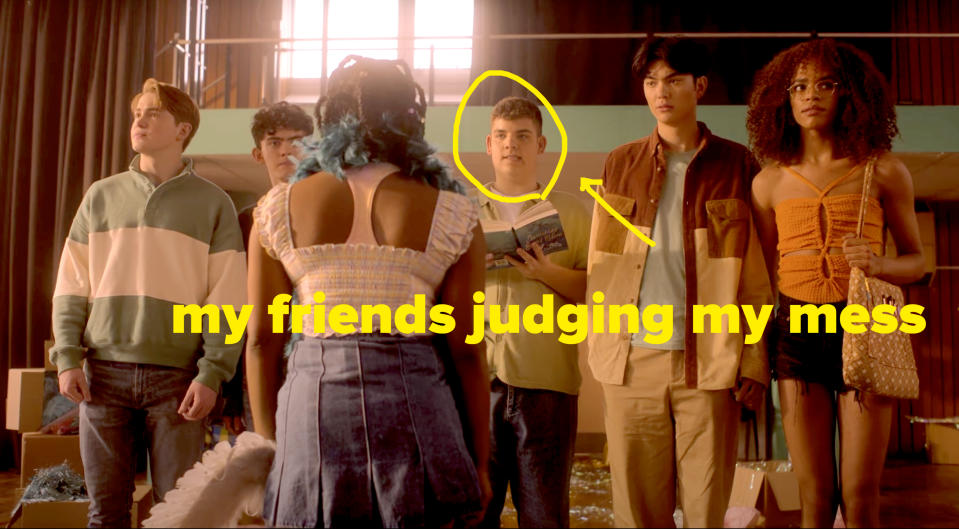 Still from Heartstopper of teenagers making a mess setting up from with the caption "judging my mess" pointing to a boy making a concerned face