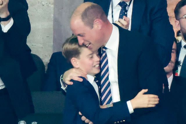<p>Jean Catuffe/Getty</p> Prince George and Prince William share a hug at the UEFA Euro final between Spain and England in Berlin, Germany on July 14, 2024.