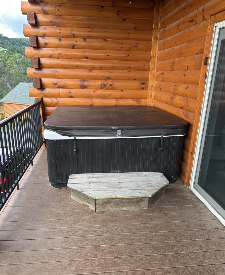 Reddit post in r/Decks with a photo of a hot tub on a wooden deck near a log cabin. The post title reads "Is this hot tub safe?"