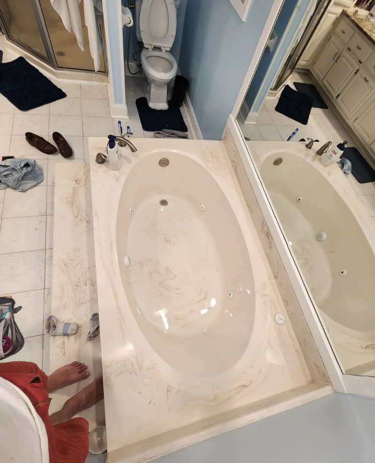 A Reddit post showing a photo of a bathroom with a bathtub full of water and a sink. The caption discusses an electrical issue in the home