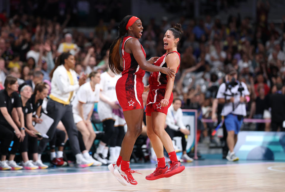 Jackie Young and Kelsey Plum celebrate during their final group stage win. (Gregory Shamus/Getty Images)
