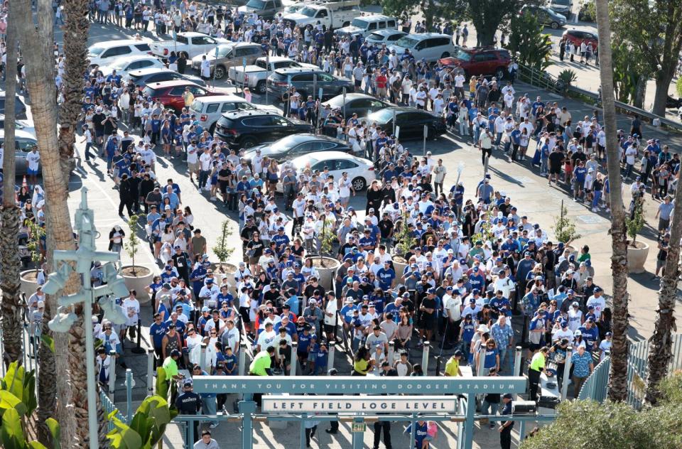 Fans wait in long lines to get their Shohei Ohtani bobblehead.