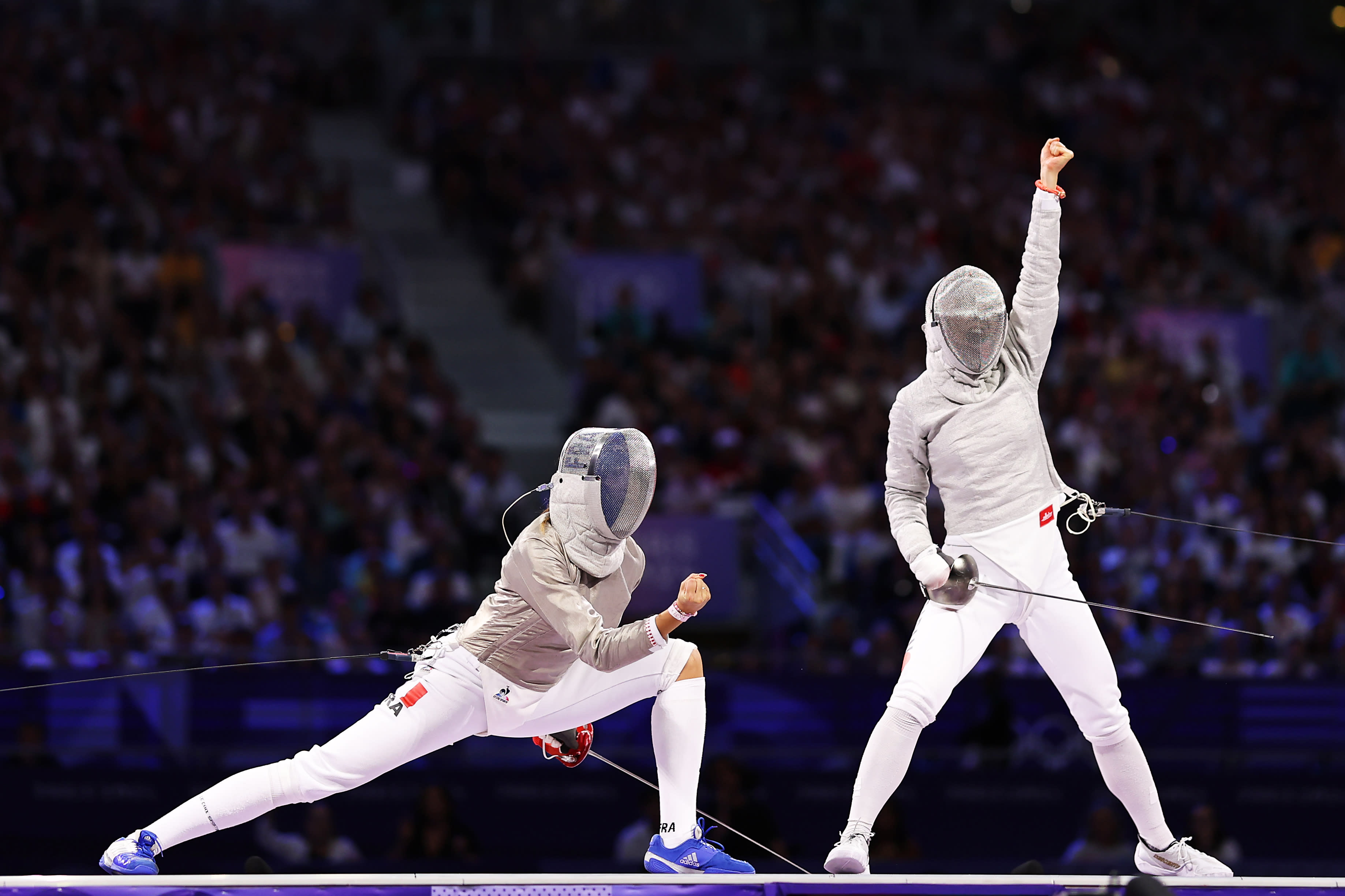 Misaki Emura (R) of Team Japan celebrates a point against Sara Balzer (L) of Team France in the Fencing Women's Sabre Team Bronze Medal match on day eight of the Olympic Games at Grand Palais on August 03, 2024 in Paris, France. (Ezra Shaw/Getty Images)