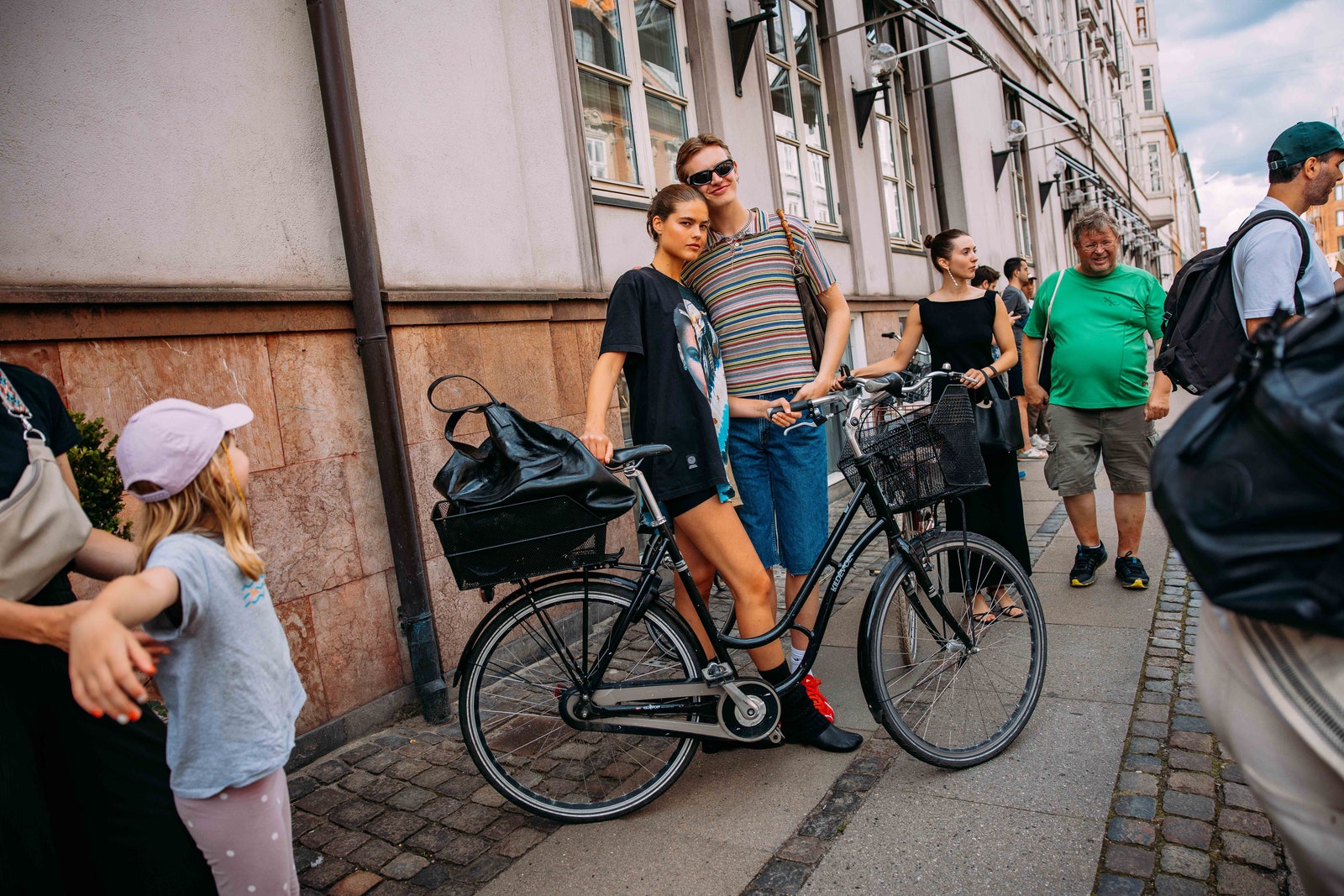 Image may contain Clothing Footwear Shoe Backpack Bag Hat Accessories Glasses Handbag Adult Person and Bicycle