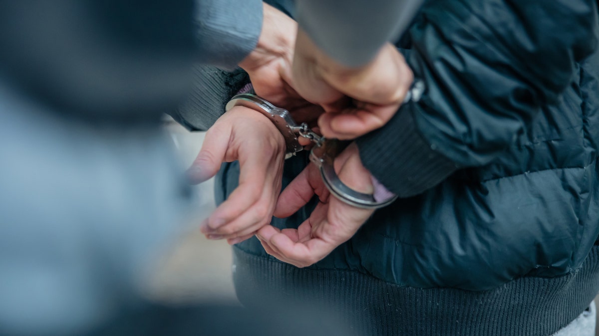 Criminal being put into handcuffs