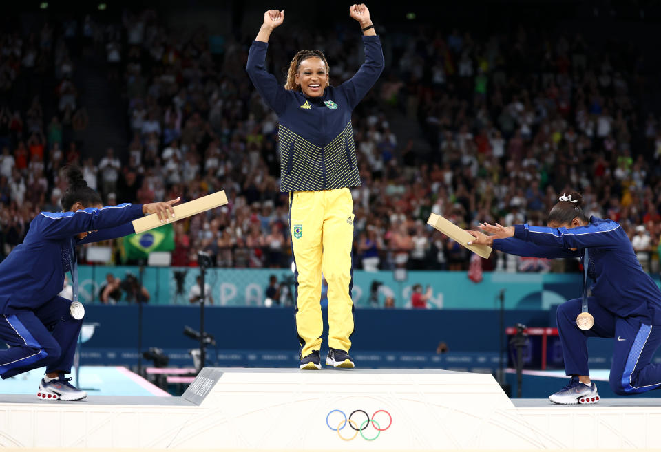 PARIS, FRANCE - AUGUST 05: Gold medalist Rebeca Andrade (C) of Team Brazil, silver medalist Simone Biles (L) of Team United States and bronze medalist Jordan Chiles (R) of Team United States celebrate on the podium at the Artistic Gymnastics Women's Floor Exercise Medal Ceremony on day ten of the Olympic Games Paris 2024 at Bercy Arena on August 05, 2024 in Paris, France. (Photo by Naomi Baker/Getty Images)