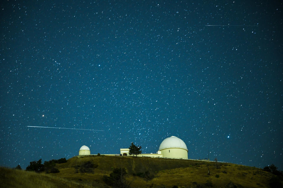 Perseid meteor shower is observed over the Lick Observatory at Mount Hamilton in California.