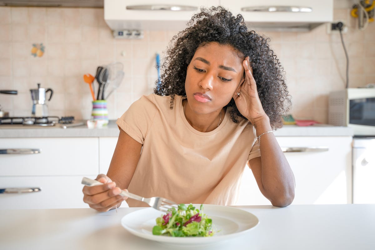 woman feeling hungry eating salad