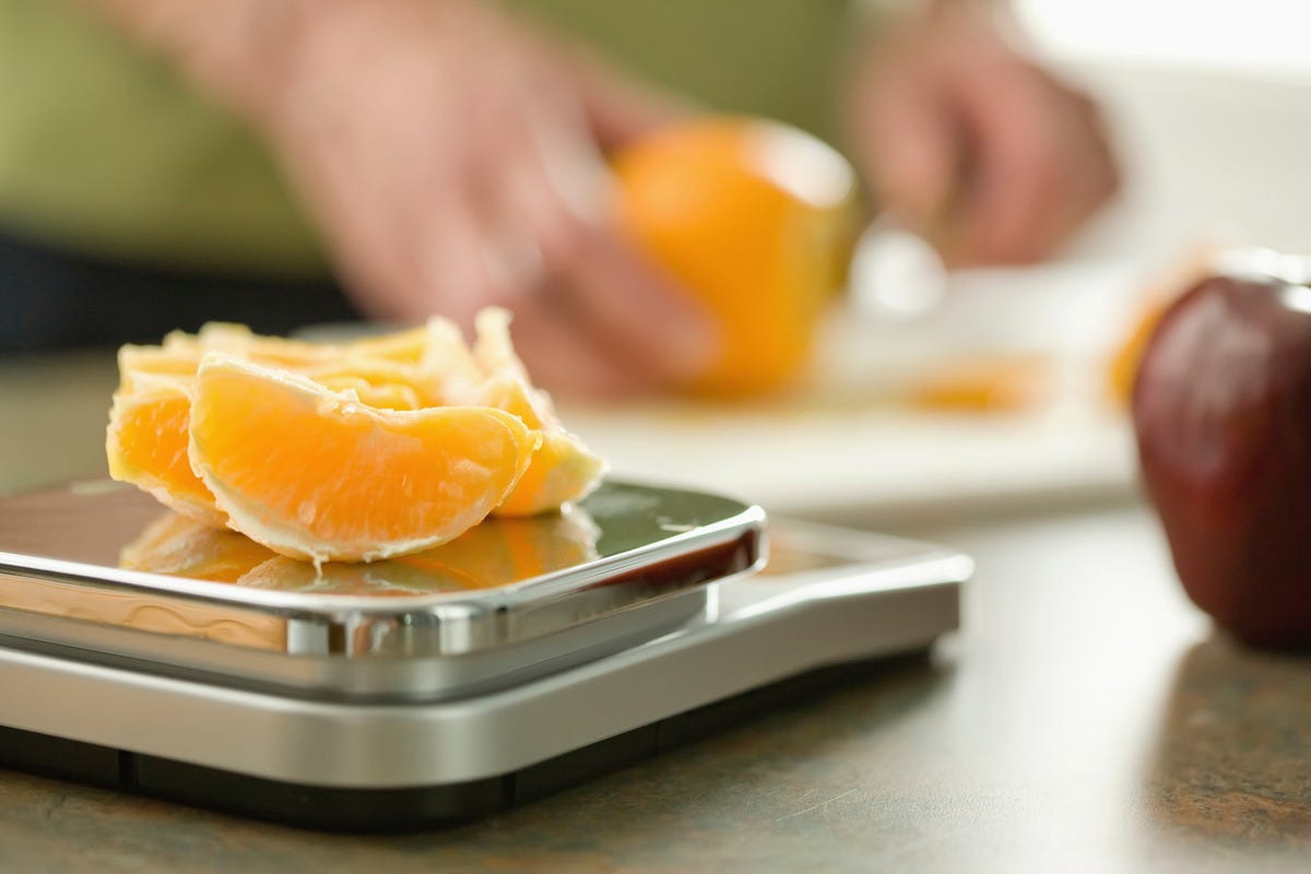 weighing orange on scale