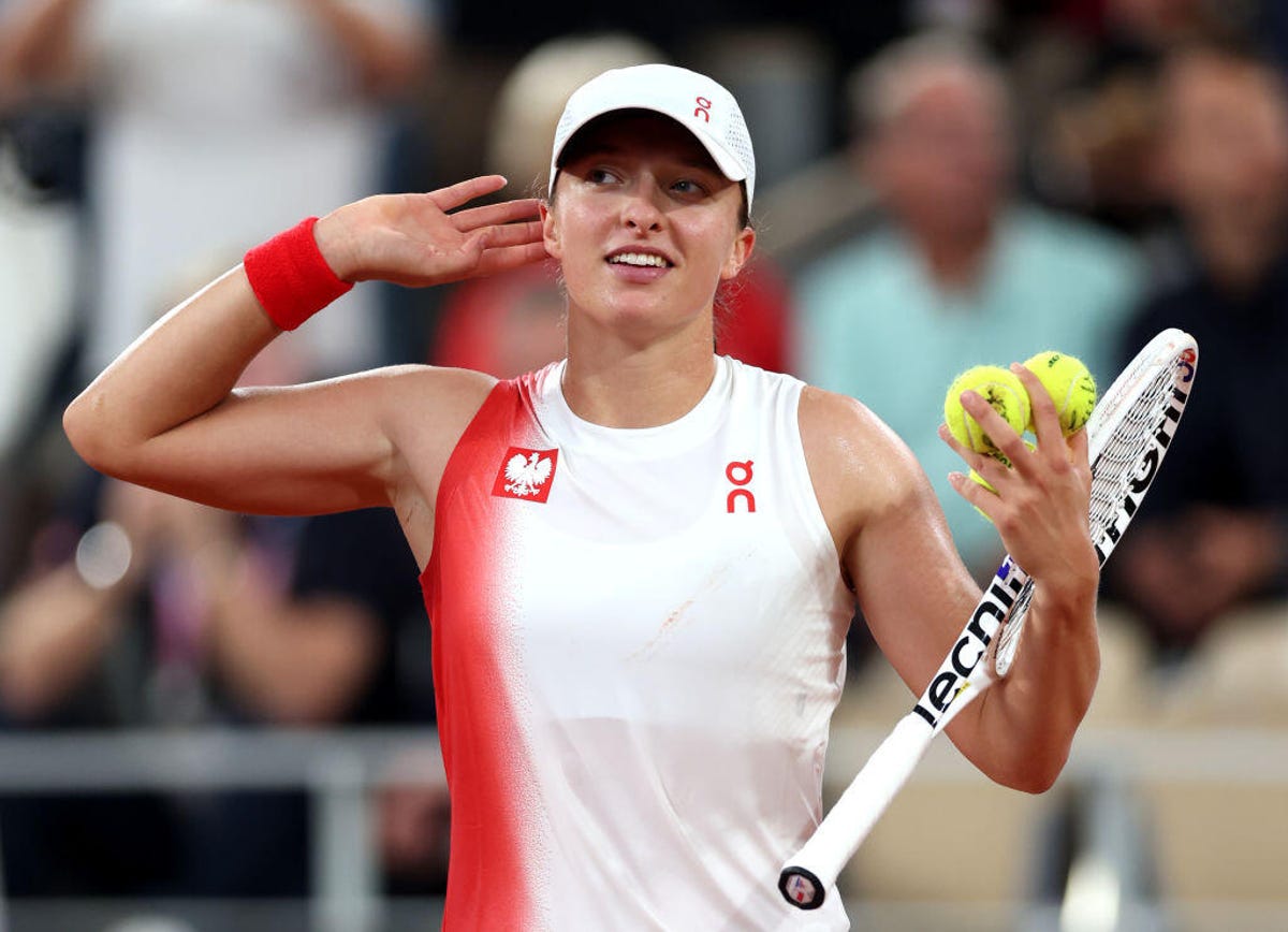 Iga Swiatek of Team Poland celebrates victory against Irina-Camelia Bego of Team Romania during the Women's Singles First Round on day one of the Olympic Games Paris 2024 at Roland Garros