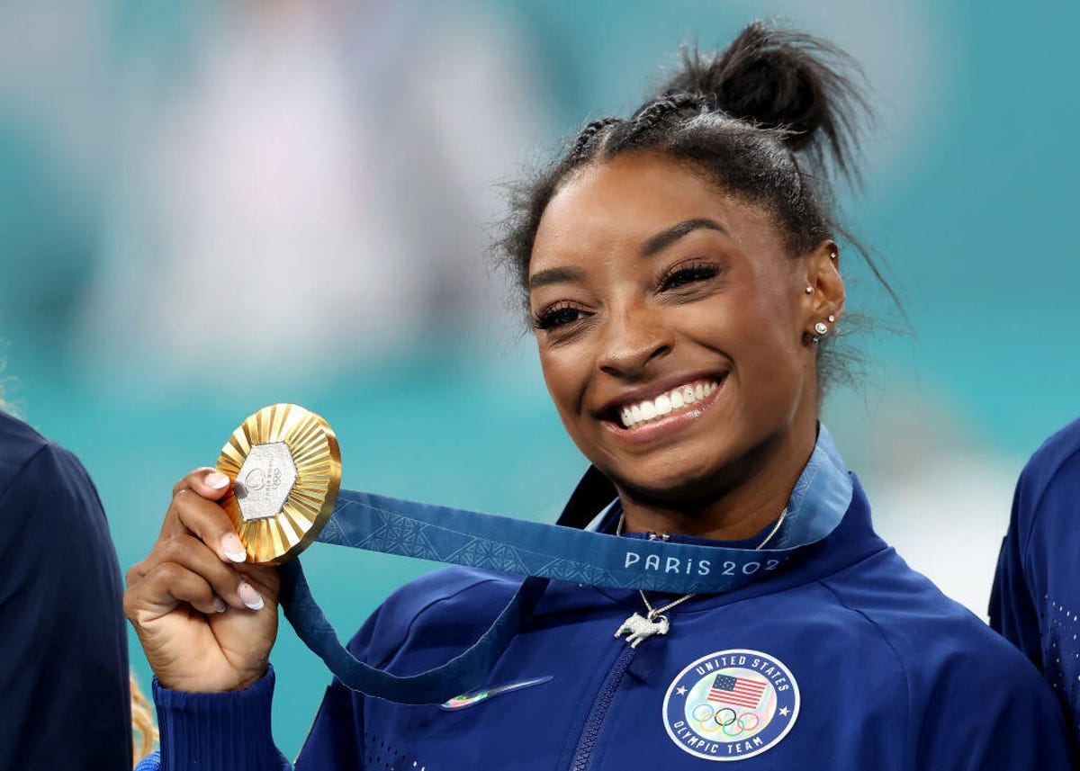 Gold medalist Simone Biles of Team United States poses during the Artistic Gymnastics Women's All-Around Final medal ceremony on day six of the Olympic Games Paris 2024 at Bercy Arena