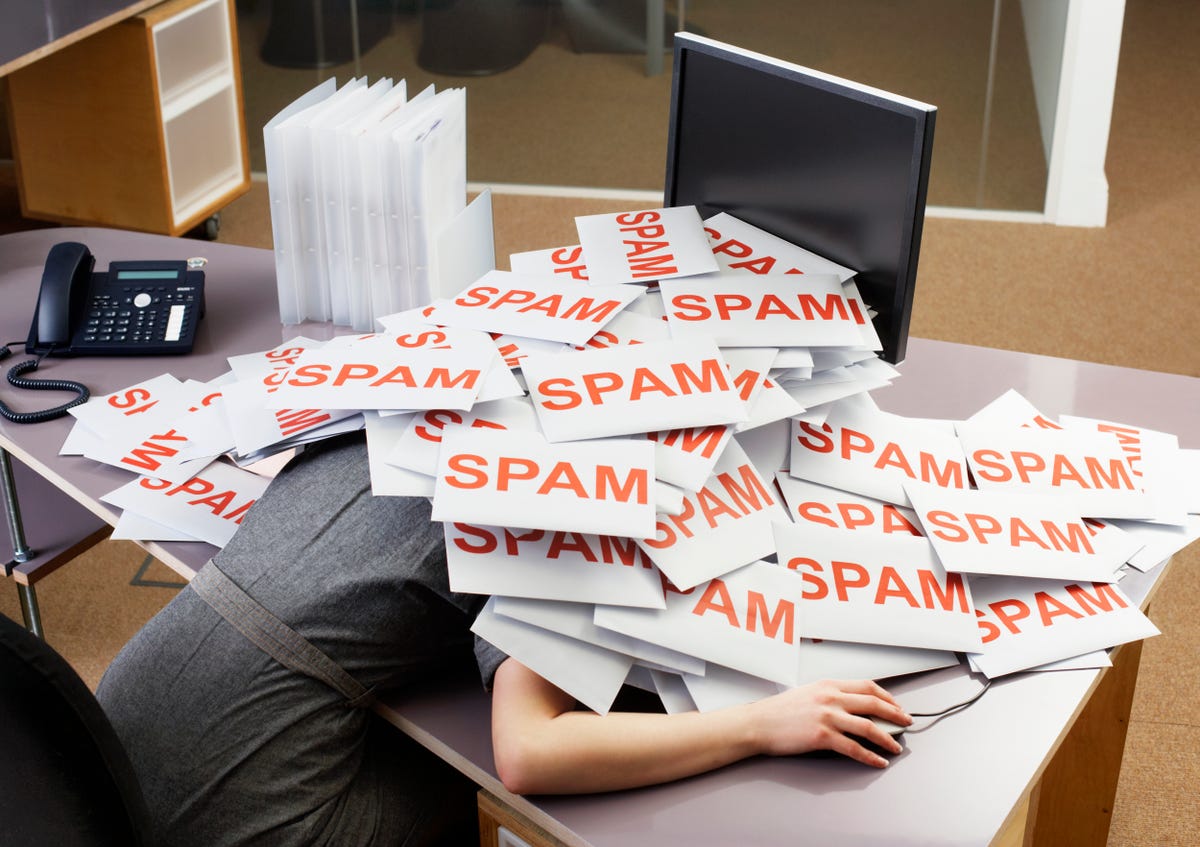 Person under a pile of papers which have the word