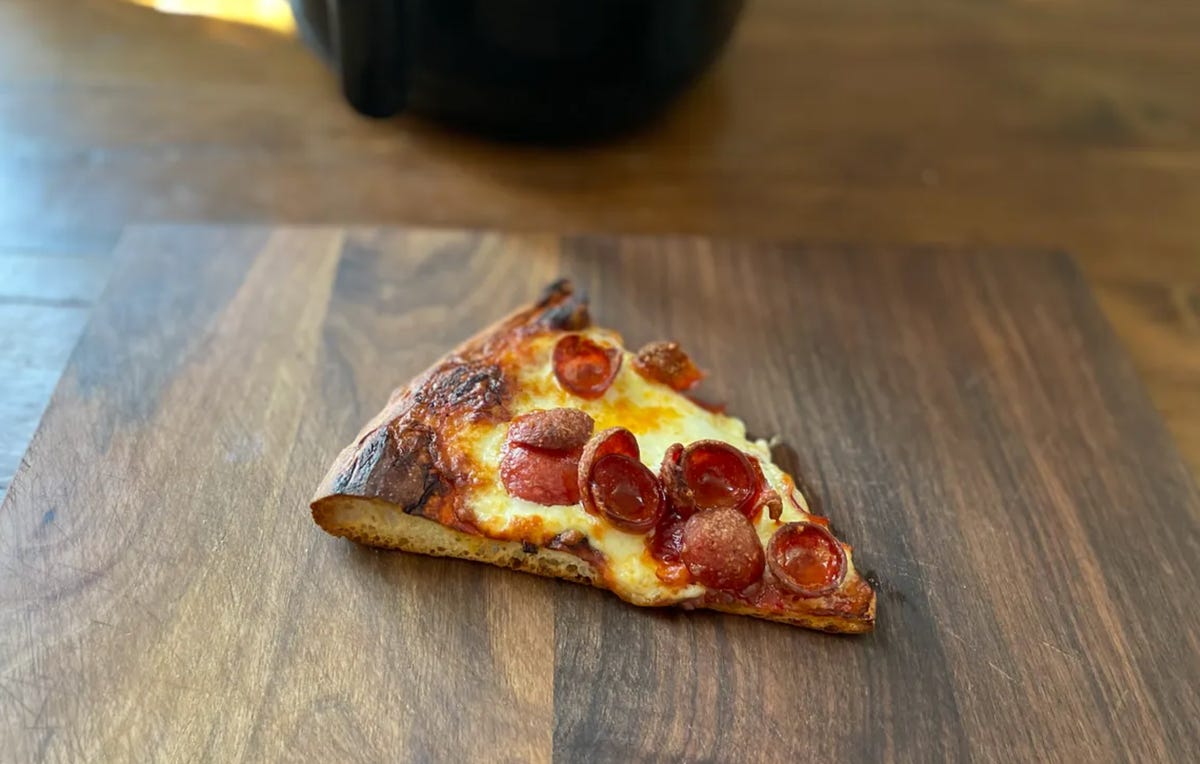 slice of pizza on cutting board