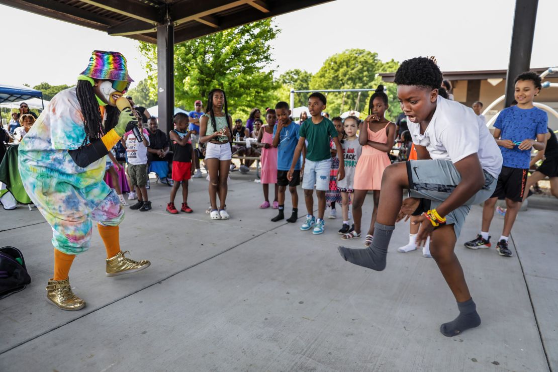 David Jefferson, 10, of shows off his dance moves to Smiley the Hip Hop Clown at an annual Juneteenth Family Reunion event in Southfield, Michigan, on June 17, 2023.