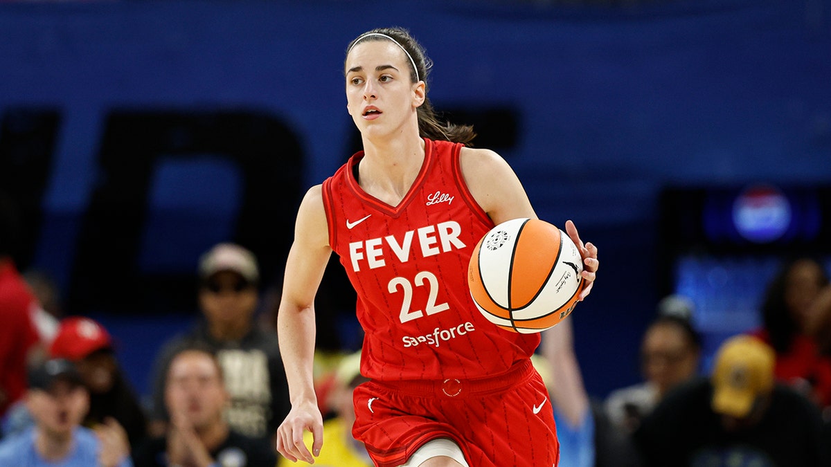 Caitlin Clark dribbles