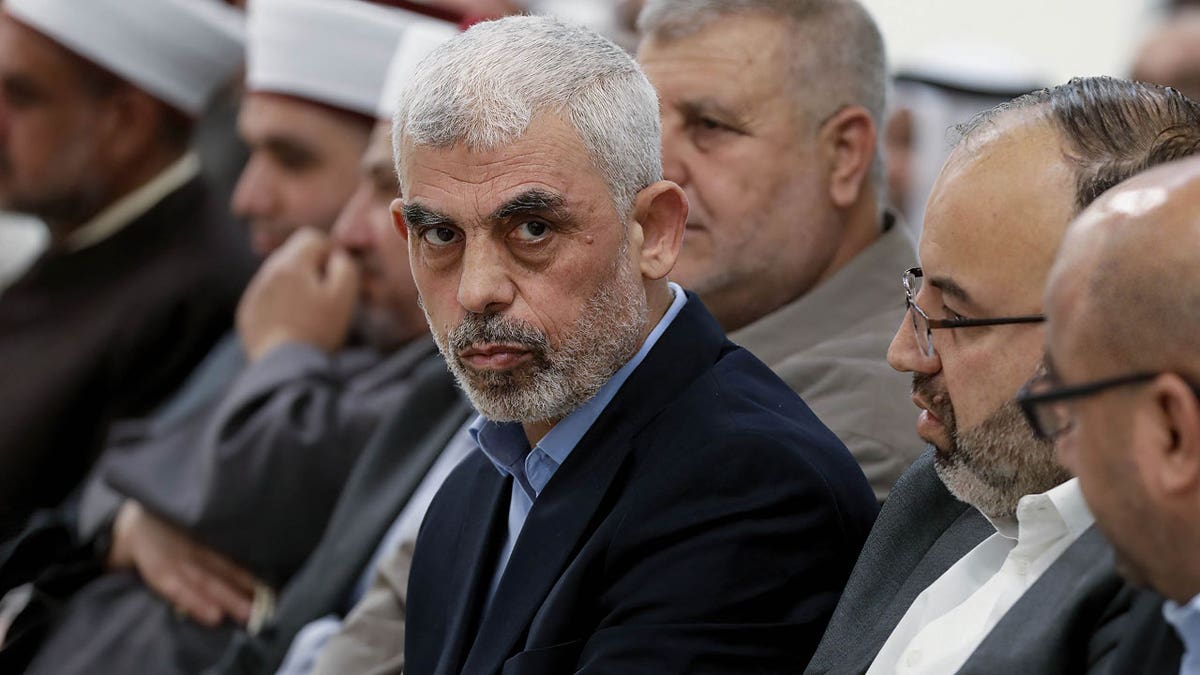 Yahya Sinwar sitting near other people