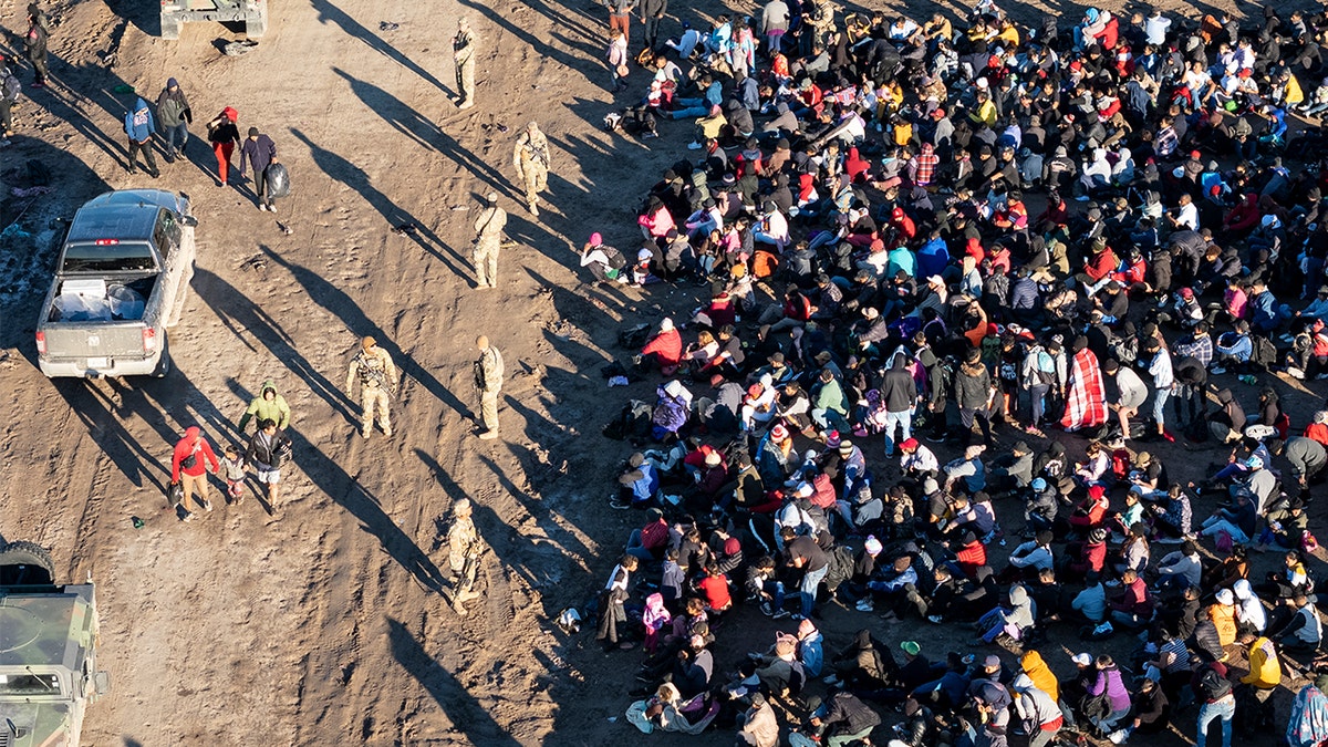 Eagle Pass border crossing seen from air with migrants massed on right