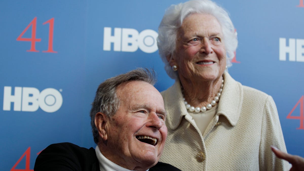 FILE - In a Tuesday, June 12, 2012 file photo, former President George H.W. Bush, and his wife, former first lady Barbara Bush, arrive for the premiere of HBO's new documentary on his life near the family compound in Kennebunkport, Maine. Bush spokesman Jim McGrath said Wednesday, Dec. 26. 2012 that doctors at the Houston hospital where Bush has been treated for a month remain cautiously optimistic that he will recover. Still, no discharge date has been set, and McGrath says that doctors are being cautious because at Bushs age sometimes issues crop up that are beyond anybodys ability to discern or foretell.(AP Photo/Charles Krupa, File)