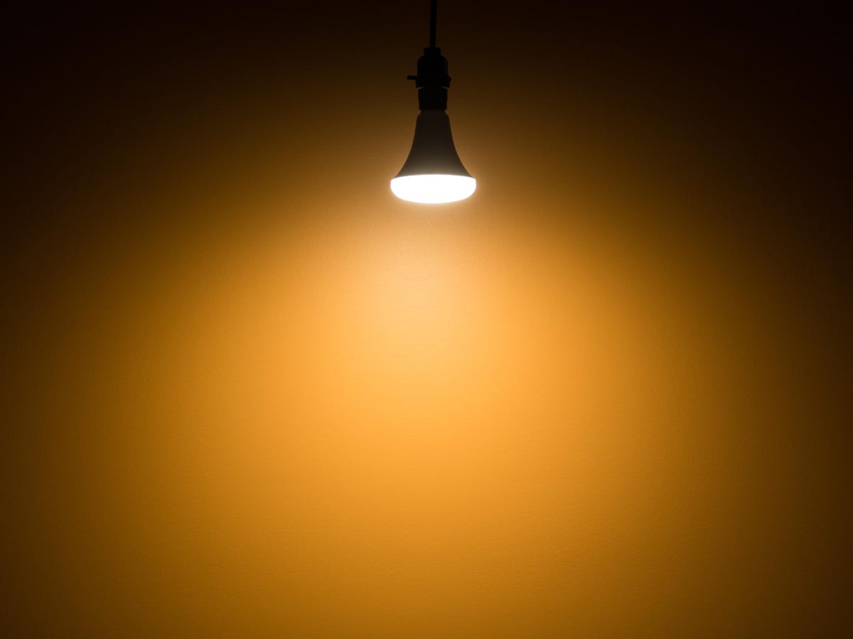 An LED light bulb lights up a small space with warm light