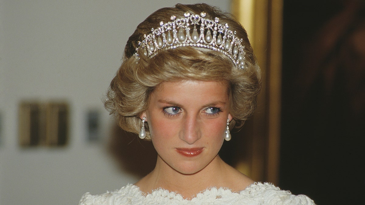 Princess Diana wearing a white dress and a tiara