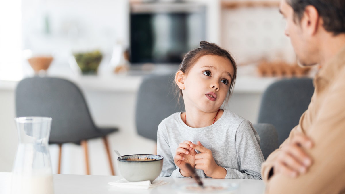 A father and daughter talking