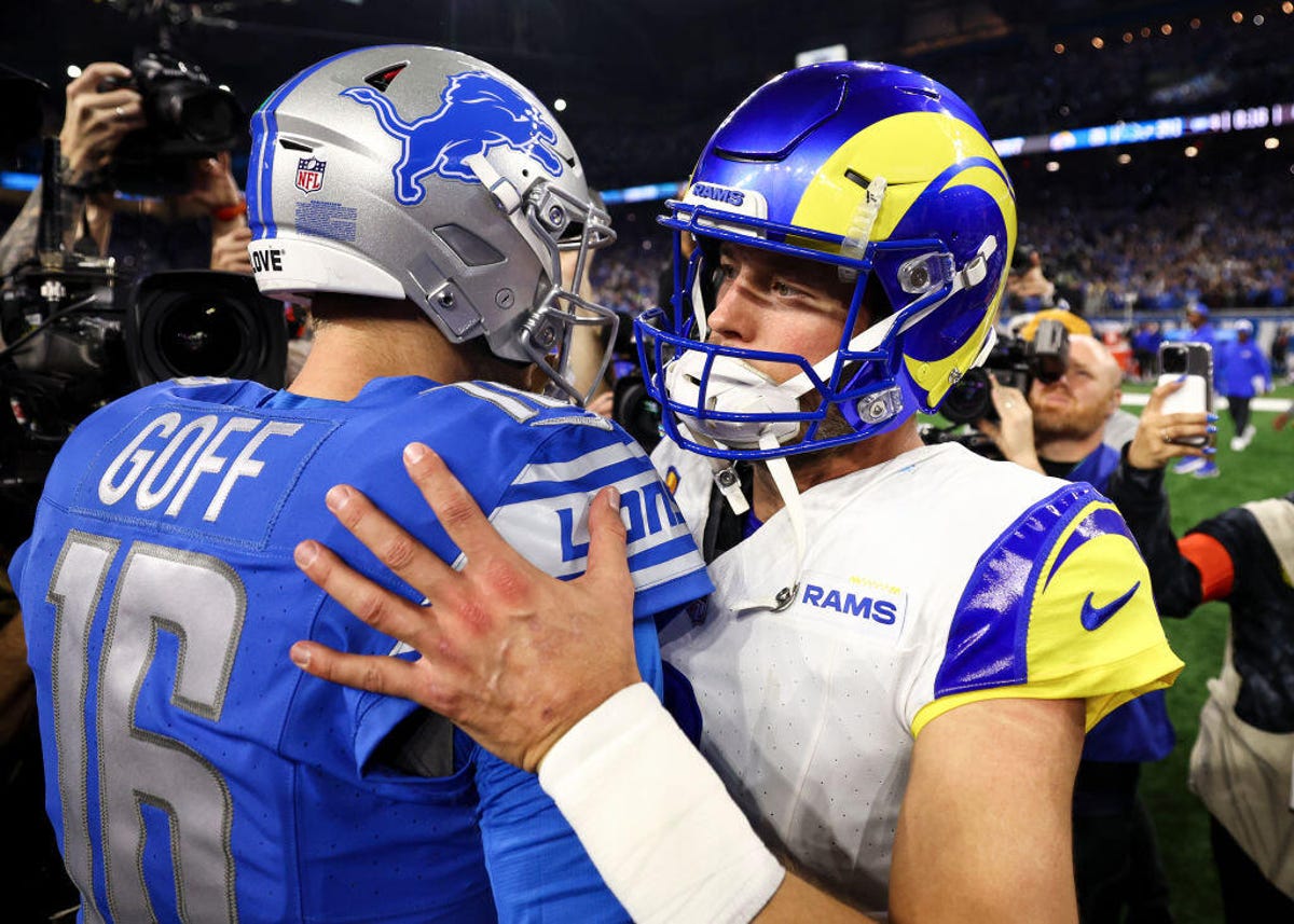 Jared Goff #16 of the Detroit Lions shakes hands with Matthew Stafford #9 of the Los Angeles Rams after an NFL wild-card playoff football game at Ford Fiel