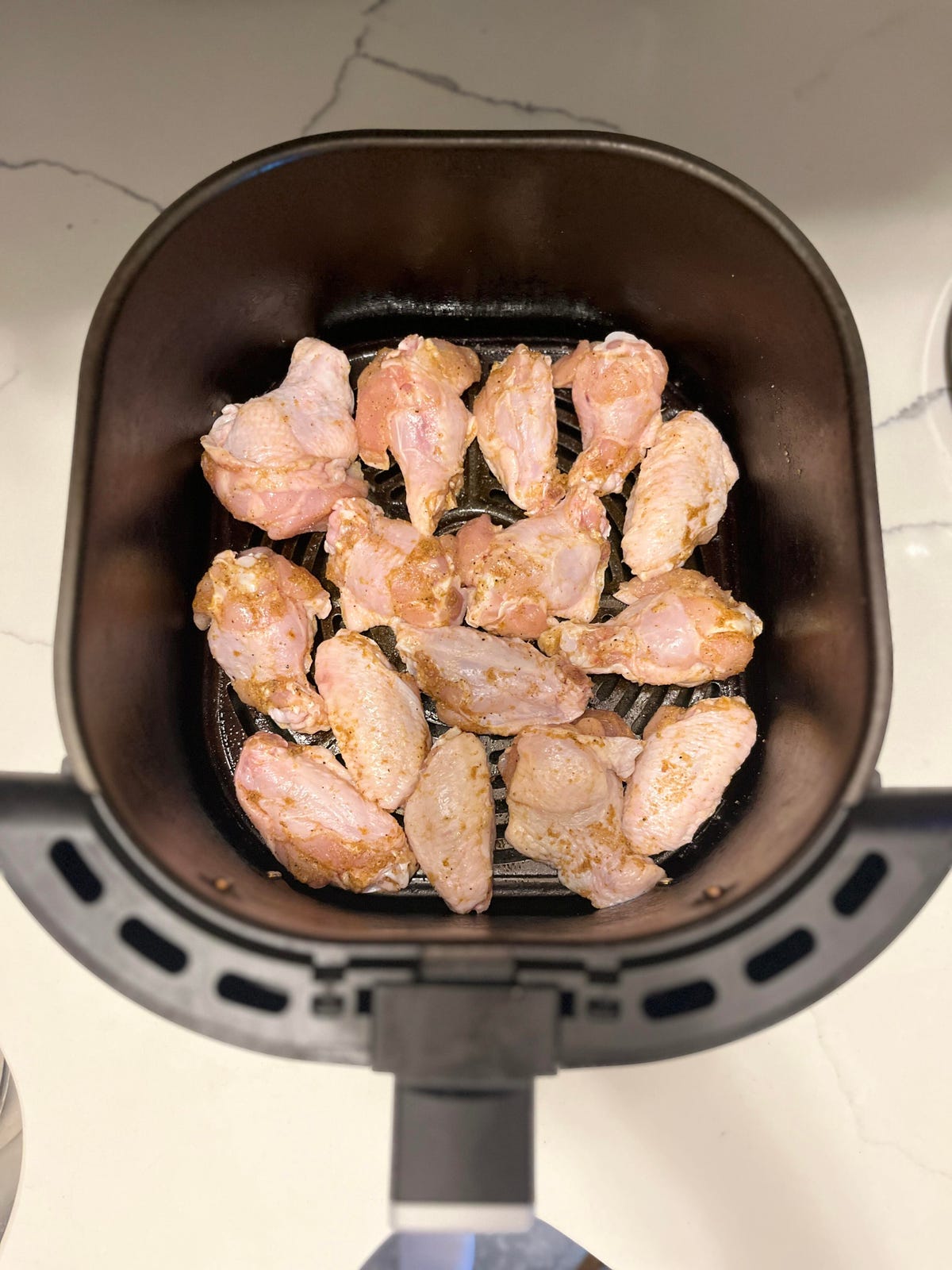 Raw chicken wings in an air fryer