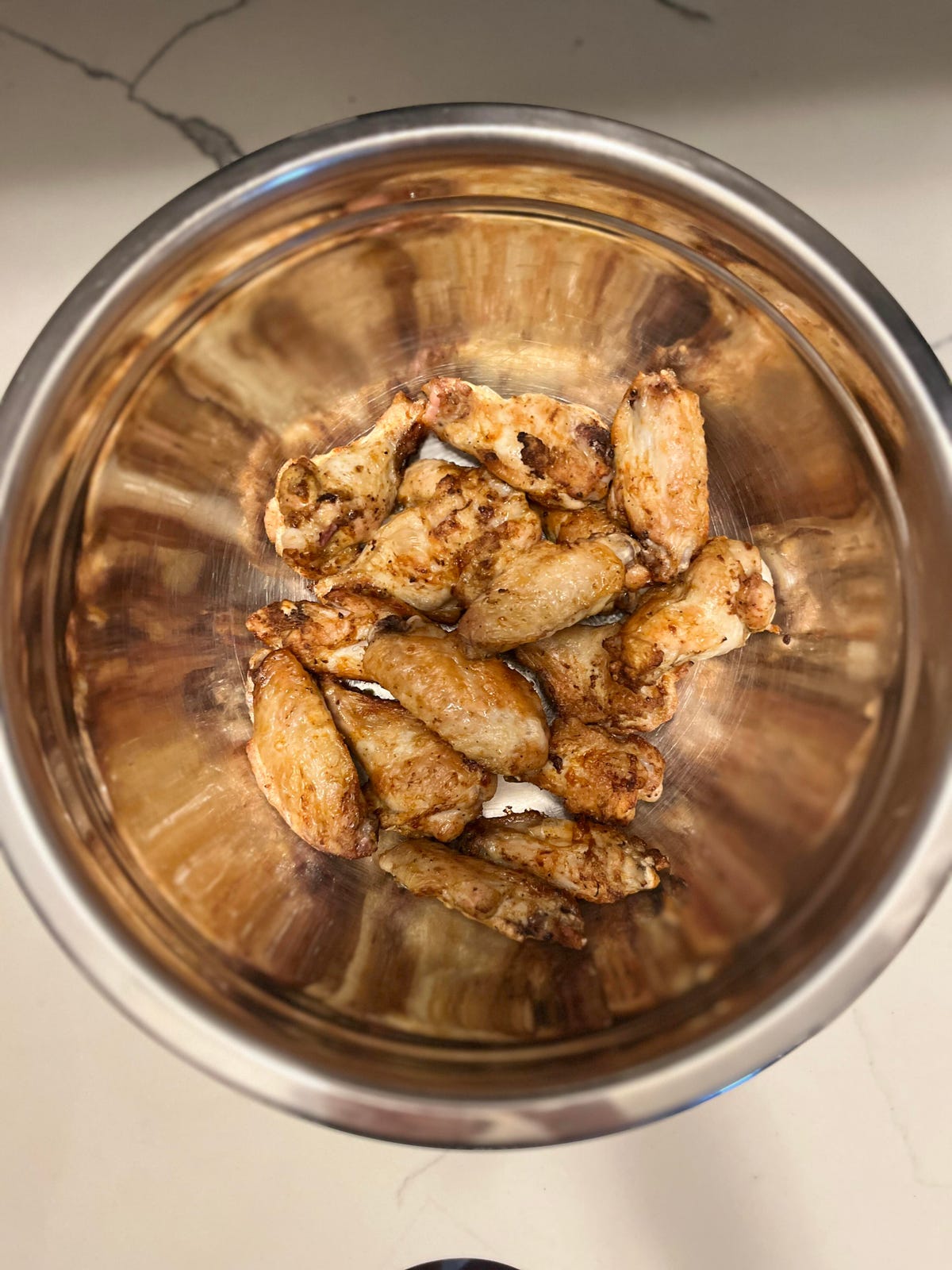 chicken wings in a stainless steel mixing bowl