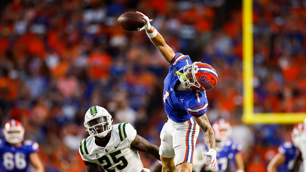 Ricky Pearsall #1 of the Florida Gators catches a pass against Prince Bemah #25 of the Charlotte 49ers during the first halfof a game at Ben Hill Griffin Stadium on September 23, 2023 in Gainesville, Florida.