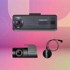 Thinkware black camera set with charging cable displayed against a purple, pink and green gradient background