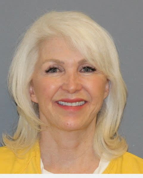 Tina Peters smiles in her mugshot.