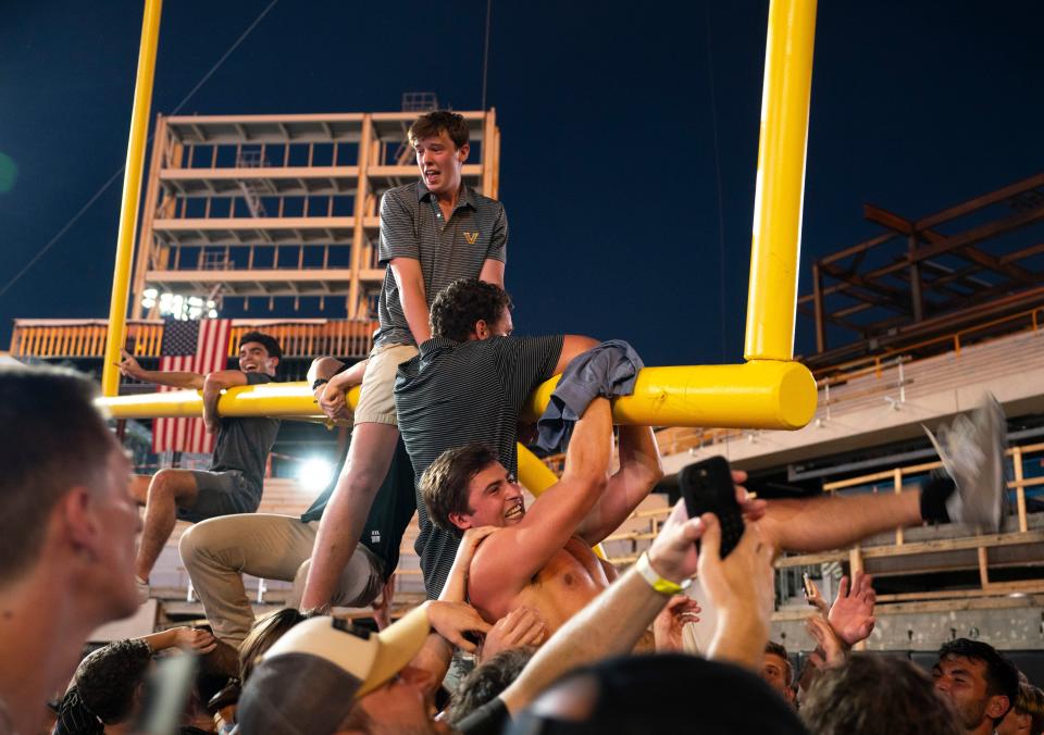 Vanderbilt fans ride the goal post in the south end of the field after the Commodores beat Alabama Saturday, Oct. 5, 2024.
