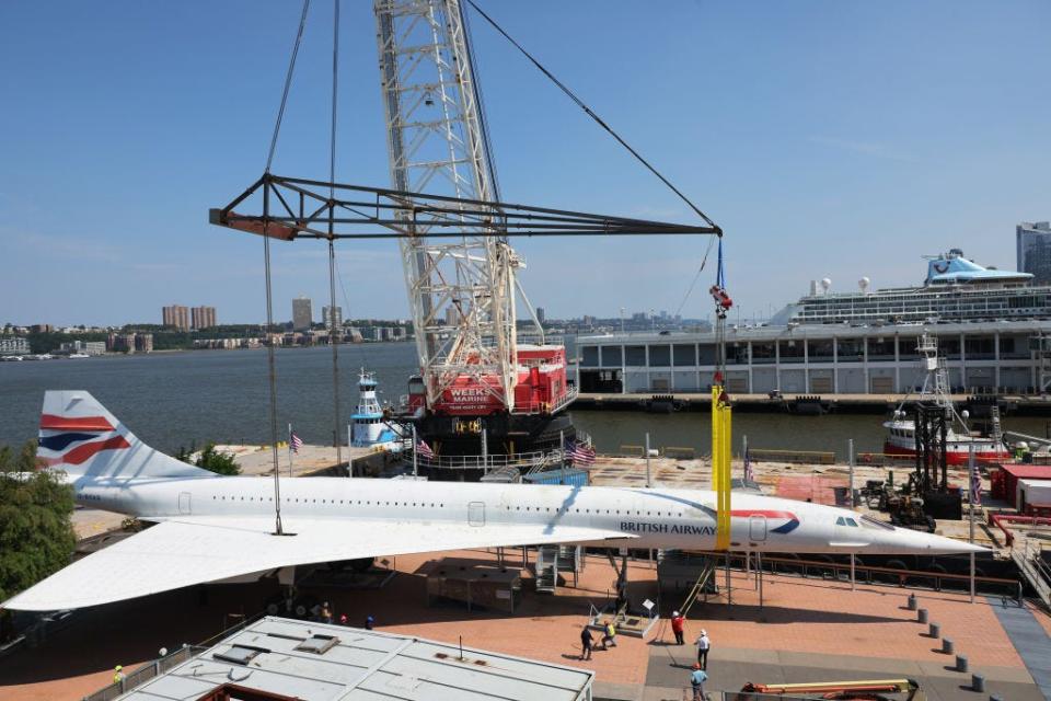 A Concorde plane arrives at the Intrepid Museum.
