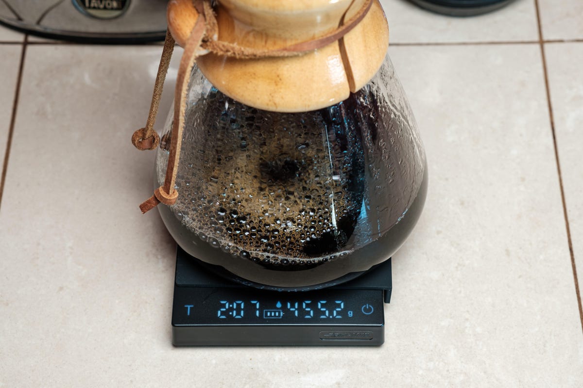 An 8-cup pour over coffee maker sits on a small coffee scale.