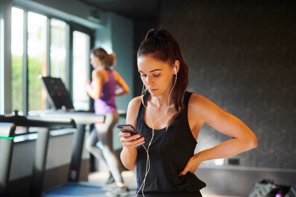 woman on smartphone at gym