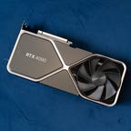 Nvidia GeForce RTX 4090 Founders Edition lying on a blue couch cushion, angled