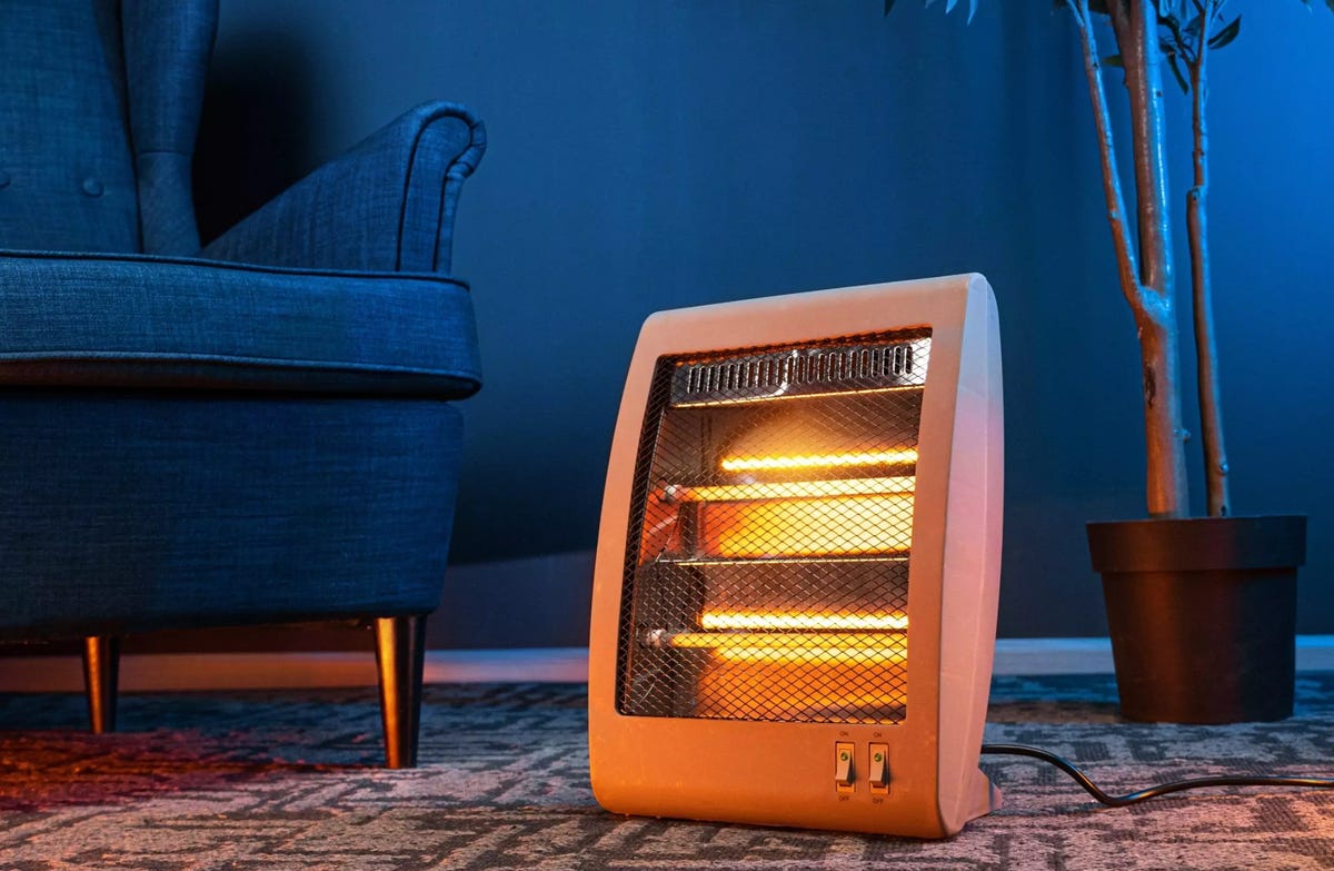 a space heater glows in a dark living room