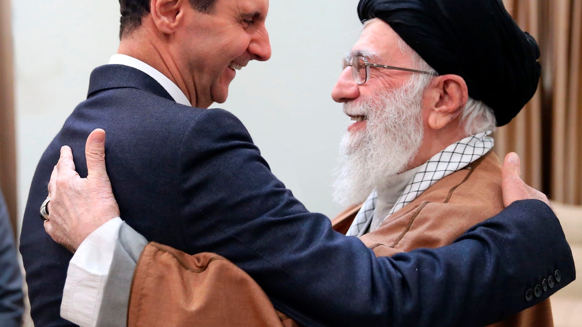 FILE - In this Feb. 25, 2019 file photo, released by an official website of the office of the Iranian supreme leader, Supreme Leader Ayatollah Ali Khamenei, right, greets Syrian President Bashar Assad, in Tehran, Iran. On Nov. 13, 1970, Hafez Assad, a young career air force officer, launched a bloodless coup. Fifty years later, his family still rules Syria. The country is in ruins from a decade of civil war that killed around a half million people, displaced half the population and virtually wiped out the economy. But Hafez’s son, Bashar Assad, has an unquestioned grip on what remains.
