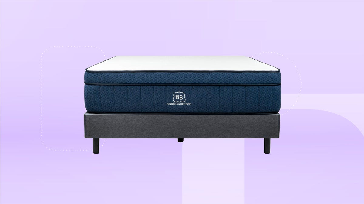 A blue and white Brooklyn Bedding mattress and grey bed frame against a purple gradient background.