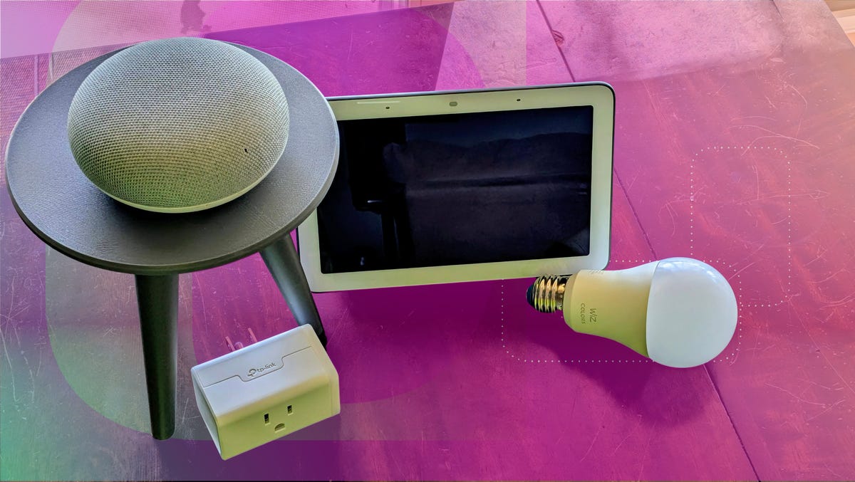 Google Nest Hub, Nest Mini, WiZ bulb, TP-Link smart plug on a table