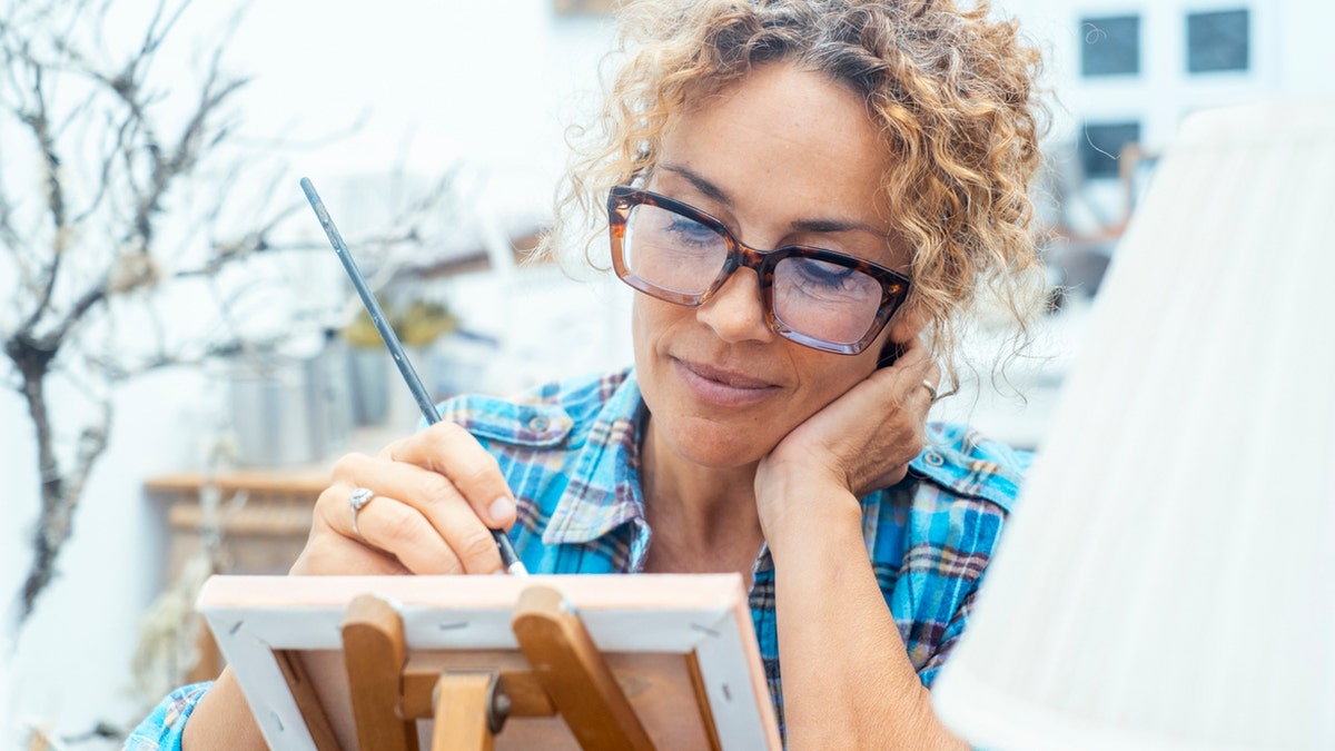 An artist painting on canvas