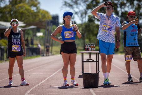 Determined to finish: Adeline Teh, in blue cap, overcome queasiness to finish her race.