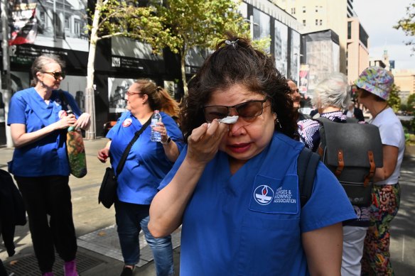 ICU nurse Wing Besilos wipes away tears at a nurses rally. 